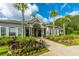 Beautiful clubhouse entrance with manicured landscaping and palm trees at 1300 Park West Blvd # 418, Mount Pleasant, SC 29466