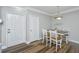 Cozy dining room with wainscoting, wood-look flooring, seating for four, and modern lighting at 1300 Park West Blvd # 418, Mount Pleasant, SC 29466