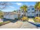 Inviting condo complex with multiple garages, mature landscaping, and accessible parking on a bright, sunny day at 1300 Park West Blvd # 418, Mount Pleasant, SC 29466