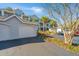 View of the condo's exterior featuring a private garage, easy parking, and mature landscaping at 1300 Park West Blvd # 418, Mount Pleasant, SC 29466