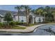 Attractive clubhouse exterior with palm trees and manicured landscaping at 1300 Park West Blvd # 418, Mount Pleasant, SC 29466