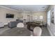 The spacious game room includes a foosball table, comfortable seating, and a TV, perfect for entertaining at 1300 Park West Blvd # 418, Mount Pleasant, SC 29466
