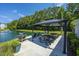 Outdoor grilling area with gazebo, tables, and grill, ideal for community gatherings by the pond at 1300 Park West Blvd # 418, Mount Pleasant, SC 29466
