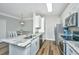Modern eat-in kitchen featuring stainless steel appliances, granite countertops, and stylish lighting at 1300 Park West Blvd # 418, Mount Pleasant, SC 29466