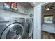Well-equipped laundry room features modern washer and dryer units and convenient shelving for storage at 1300 Park West Blvd # 418, Mount Pleasant, SC 29466