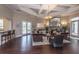 Spacious living room with hardwood floors, stone fireplace, sofas, and access to outdoor pool at 1300 Park West Blvd # 418, Mount Pleasant, SC 29466