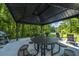 Close up view of an outdoor pavilion with picnic tables and grill with a view of a lake at 1300 Park West Blvd # 418, Mount Pleasant, SC 29466