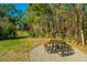 Community picnic area with a round table and benches on a gravel surface at 1300 Park West Blvd # 418, Mount Pleasant, SC 29466
