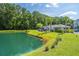 Scenic view of a pond with a gazebo, palm trees, and lush greenery, perfect for relaxation at 1300 Park West Blvd # 418, Mount Pleasant, SC 29466
