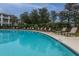 Large community pool with lounge chairs providing an inviting space for relaxation and recreation at 1300 Park West Blvd # 418, Mount Pleasant, SC 29466