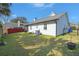 Wide angle of the back of the home and a well-maintained backyard at 135 Toura Ln, Charleston, SC 29414