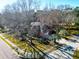 Aerial view of a beautiful red brick home with a two-car garage, mature trees, and a circular driveway at 1407 Congressional Blvd, Summerville, SC 29483