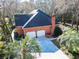 Aerial view showcasing a stunning brick home with palm trees and a spacious driveway at 1407 Congressional Blvd, Summerville, SC 29483