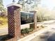 Elegant brick sign for 'The Club Pine Forest' community, set amidst lush greenery and mature trees at 1407 Congressional Blvd, Summerville, SC 29483