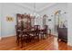 Bright formal dining room featuring hardwood floors, a large window, and an elegant chandelier at 1407 Congressional Blvd, Summerville, SC 29483