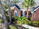 Beautiful brick home with a welcoming front porch, lush landscaping, and mature palm trees at 1407 Congressional Blvd, Summerville, SC 29483