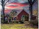 Charming brick home with manicured lawn, lush landscaping, and vibrant plants at sunset at 1407 Congressional Blvd, Summerville, SC 29483