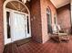 Inviting brick porch features two rocking chairs, tiled flooring, and a charming entryway at 1407 Congressional Blvd, Summerville, SC 29483