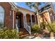 Lovely brick home featuring a white columned front porch and well-maintained landscaping at 1407 Congressional Blvd, Summerville, SC 29483