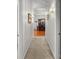 Bright hallway with neutral walls leading into an elegant dining room with a classic chandelier and wooden furniture at 1407 Congressional Blvd, Summerville, SC 29483