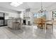 Bright kitchen with stainless steel appliances, white cabinets, and an eat-in area with large windows at 1407 Congressional Blvd, Summerville, SC 29483