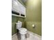 Powder room with neutral tile floors and green walls at 1407 Congressional Blvd, Summerville, SC 29483
