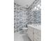 Charming powder room with designer wallpaper, white vanity, and decorative mirror at 1407 Congressional Blvd, Summerville, SC 29483
