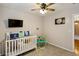 Inviting Bedroom featuring a crib, a ceiling fan, and decor for a comfortable and playful space at 1452 Water Edge Dr, Charleston, SC 29492