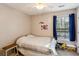 Cozy bedroom featuring a ceiling fan and a window with blue curtains for a tranquil setting at 1452 Water Edge Dr, Charleston, SC 29492