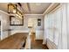 Open-concept dining room with a large wooden table, stylish light fixture, and natural light at 1452 Water Edge Dr, Charleston, SC 29492