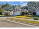 Charming two-story home featuring a manicured lawn, two-car garage, and inviting curb appeal at 1452 Water Edge Dr, Charleston, SC 29492