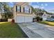 Two-story home with a two-car garage, spacious driveway, and neatly landscaped front yard at 1452 Water Edge Dr, Charleston, SC 29492