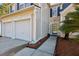 Close-up view of a charming home's entrance, showcasing the two-car garage and beautifully landscaped walkway at 1452 Water Edge Dr, Charleston, SC 29492