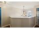 Upstairs hallway with a decorative chandelier and natural light from a window at 1452 Water Edge Dr, Charleston, SC 29492