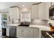 Bright kitchen with white cabinets, gray subway tile, stainless steel appliances, and quartz countertops at 1452 Water Edge Dr, Charleston, SC 29492