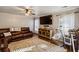 Inviting living room featuring a leather sectional sofa, ceiling fan, and large area rug at 1452 Water Edge Dr, Charleston, SC 29492