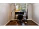 Modern office space featuring hardwood floors, a window, a unique lamp, and a functional work area at 1452 Water Edge Dr, Charleston, SC 29492