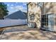 Outdoor patio perfect for gatherings, featuring a stone surface, sliding door access, and fenced yard at 1452 Water Edge Dr, Charleston, SC 29492