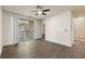 Living room features a ceiling fan, hardwood floors, sliding doors to a balcony, and a white door to the side at 1600 Long Grove Dr # 1313, Mount Pleasant, SC 29466