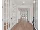 Light-filled hallway with hardwood floors and stylish white doors at 1640 Siloh Siloh Dr # 477, Mount Pleasant, SC 29466