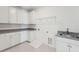 Bright laundry room with granite countertops, white cabinets, and tile flooring at 1640 Siloh Siloh Dr # 477, Mount Pleasant, SC 29466