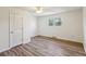 Comfortable bedroom with wood-look flooring, ceiling fan, and natural light at 1735 Boone Hall Dr # K14, Charleston, SC 29407