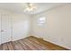 Comfortable bedroom with wood-look flooring, ceiling fan, and natural light at 1735 Boone Hall Dr # K14, Charleston, SC 29407