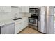 Renovated kitchen showcasing stainless steel appliances and white cabinets at 1735 Boone Hall Dr # K14, Charleston, SC 29407