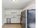 Updated kitchen with stainless steel appliances, neutral tile floors and white cabinetry at 1735 Boone Hall Dr # K14, Charleston, SC 29407