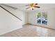 Bright living room with neutral tile flooring, a ceiling fan and a staircase at 1735 Boone Hall Dr # K14, Charleston, SC 29407