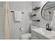 Beautifully renovated bathroom features floating shelves and contrasting dark fixtures for a modern touch at 1836 Mepkin Rd # D4, Charleston, SC 29407