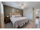 Bedroom with a modern wooden headboard, ceiling fan, light gray walls, and hardwood flooring at 1836 Mepkin Rd # D4, Charleston, SC 29407