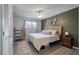 Stylish bedroom with a wooden slat headboard, ceiling fan, and colorful area rug at 1836 Mepkin Rd # D4, Charleston, SC 29407