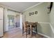 Dining area with sliding door to outdoor patio, bar seating, and neutral paint at 1836 Mepkin Rd # D4, Charleston, SC 29407